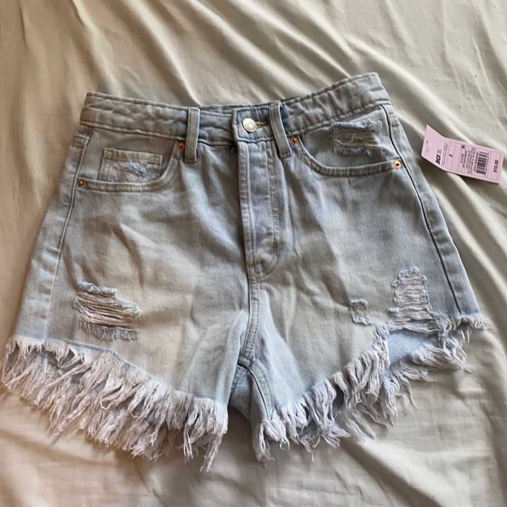 Light jean shorts ripped at the bottom